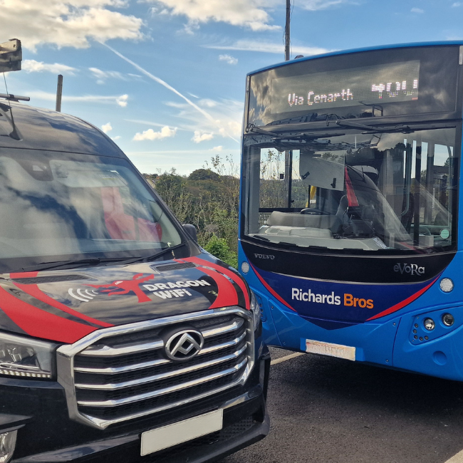 Dragon WiFi van next to a public transport bus