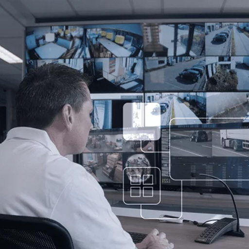 A man watching multiple CCTV screens